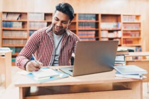 Indian ethnicity student working in a public library